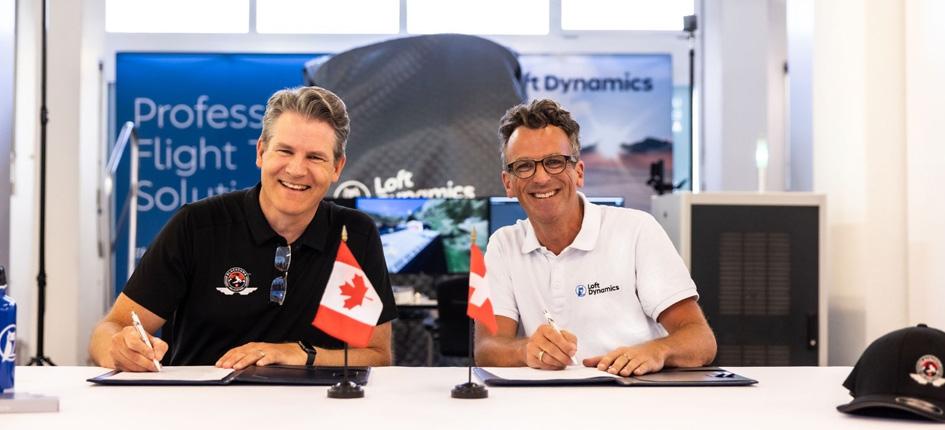 Chris Haslock, Blackcomb's director of operations (left), and Fabi Riesen, founder and CEO of Loft Dynamics, sign the agreement to purchase the simulator. Image provided by Loft Dynamics