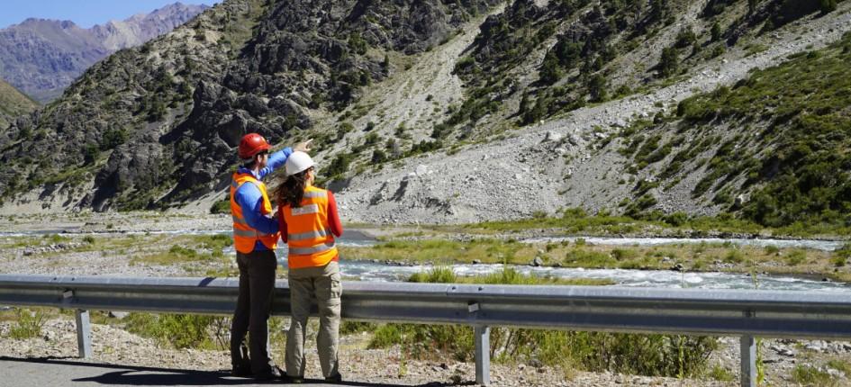 Two engineers look at the Chilean mountains