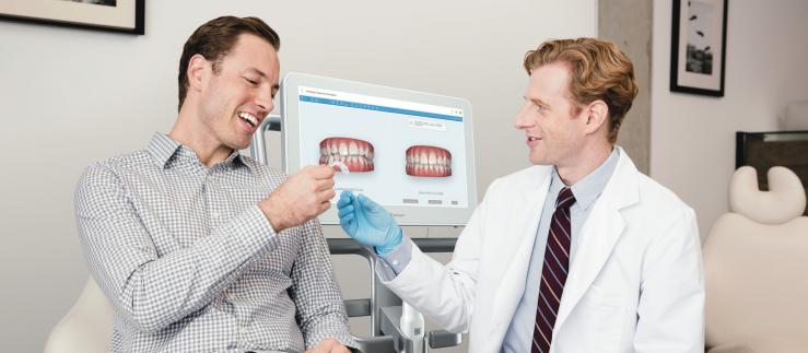 dentist and patient with aligner