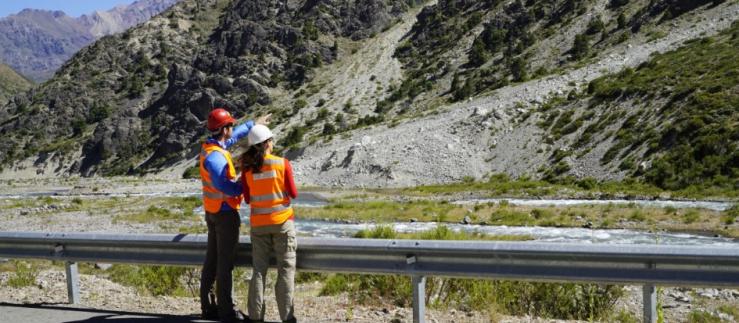 Two engineers look at the Chilean mountains