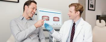 dentist and patient with aligner