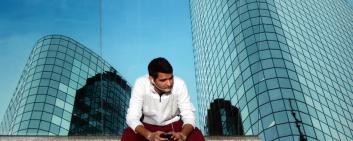 Young Indian business man talks on a smartphone